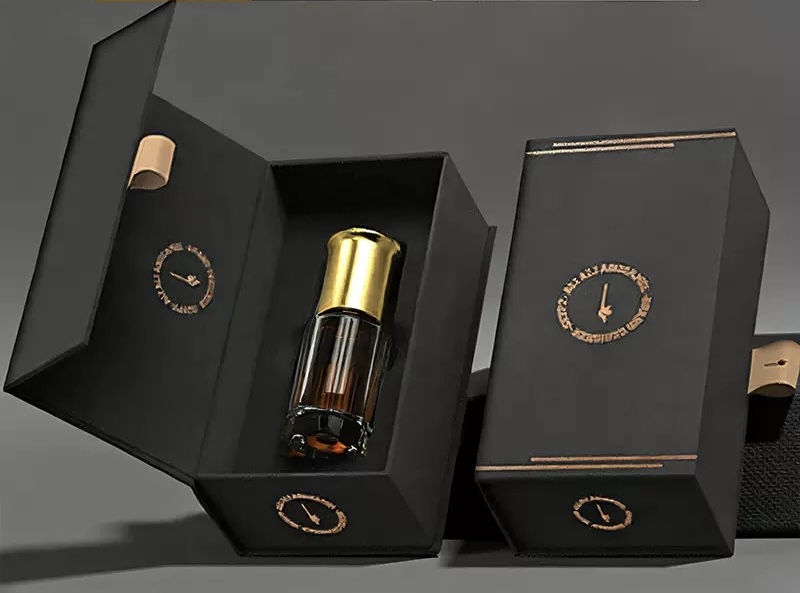 Black and gold folding perfume presentation box with a fitted insert