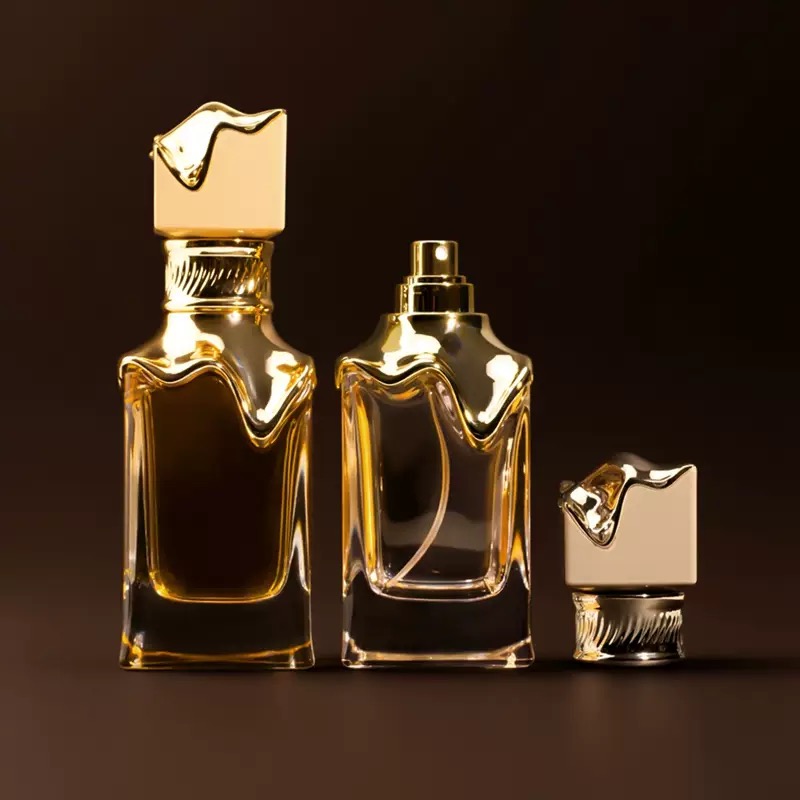 Sculptural gold-accent perfume bottle set with matching cap and sprayer