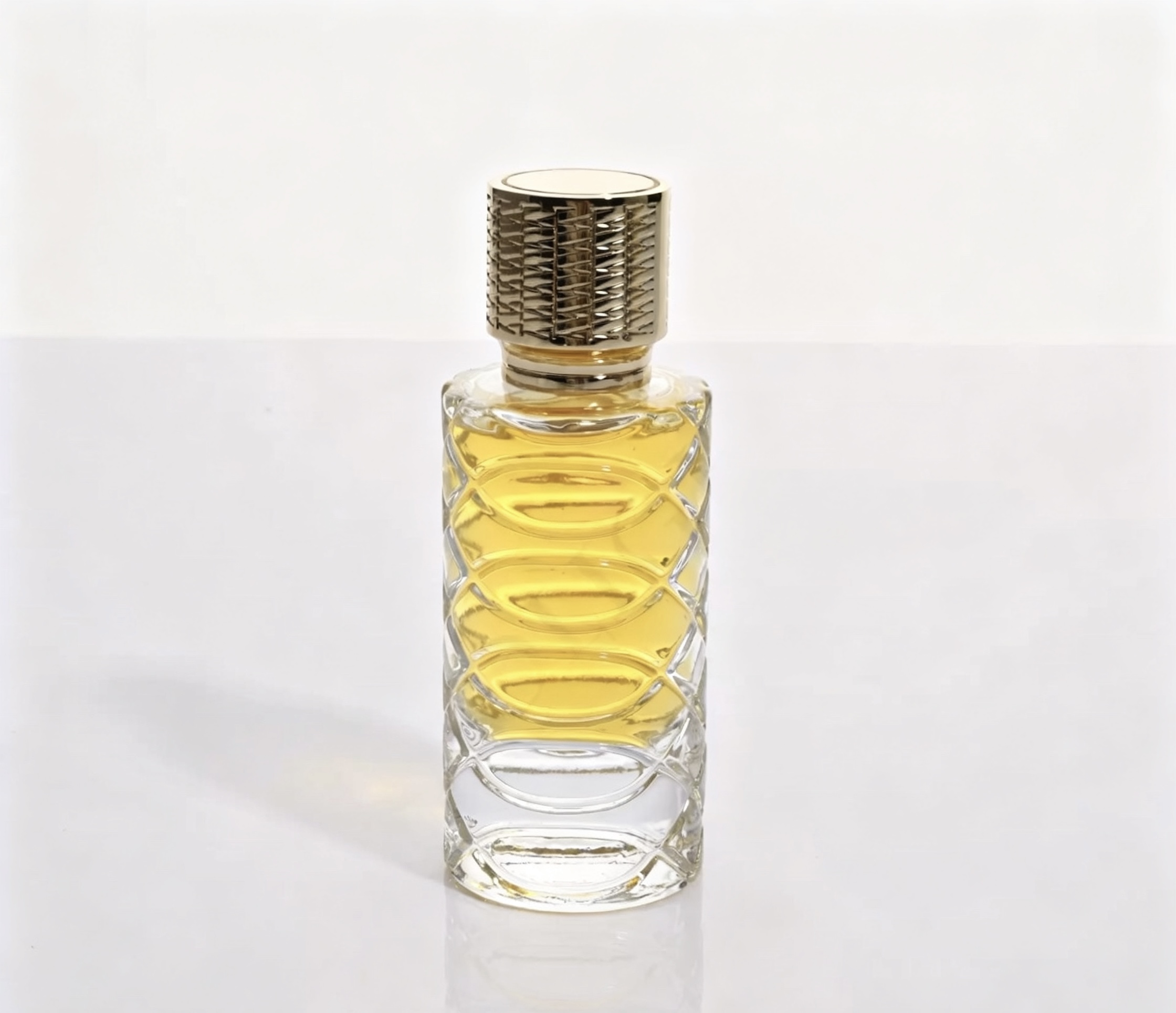 Clear cylindrical perfume bottle with a textured glass pattern