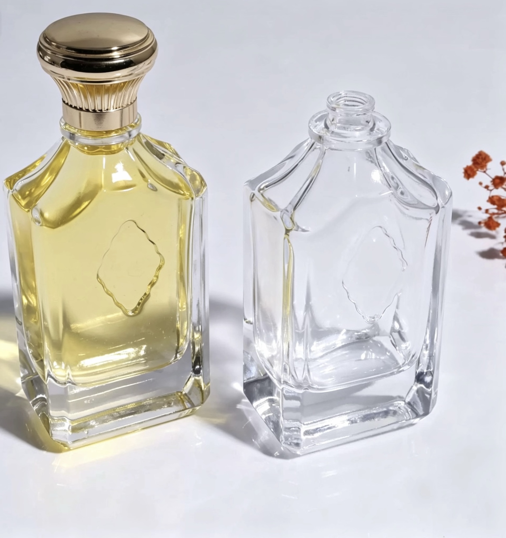Pair of faceted rectangular clear glass perfume bottles